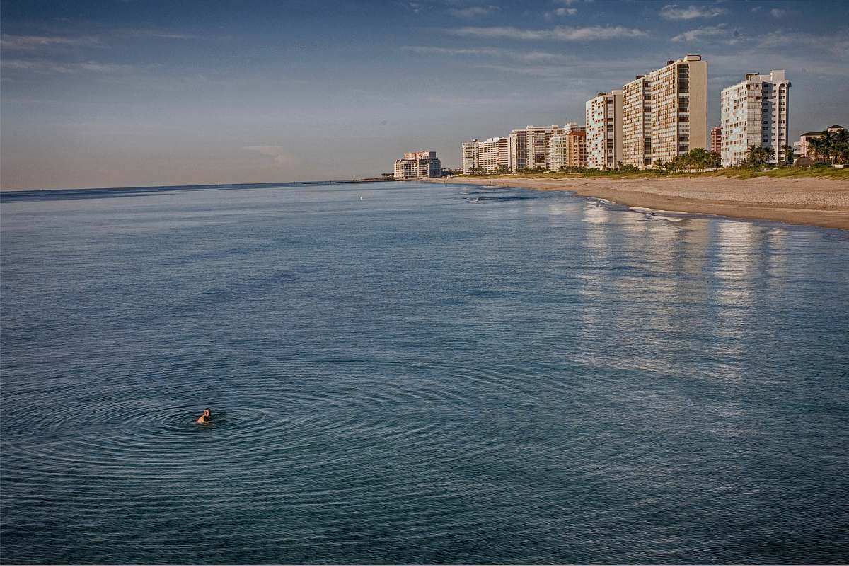 deerfield beach person swimming in the ocean during cloudy day united states
